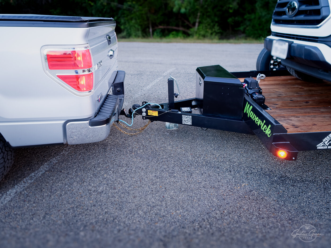 Coupler hitched to a pickup's ball, safety chains and wiring connected